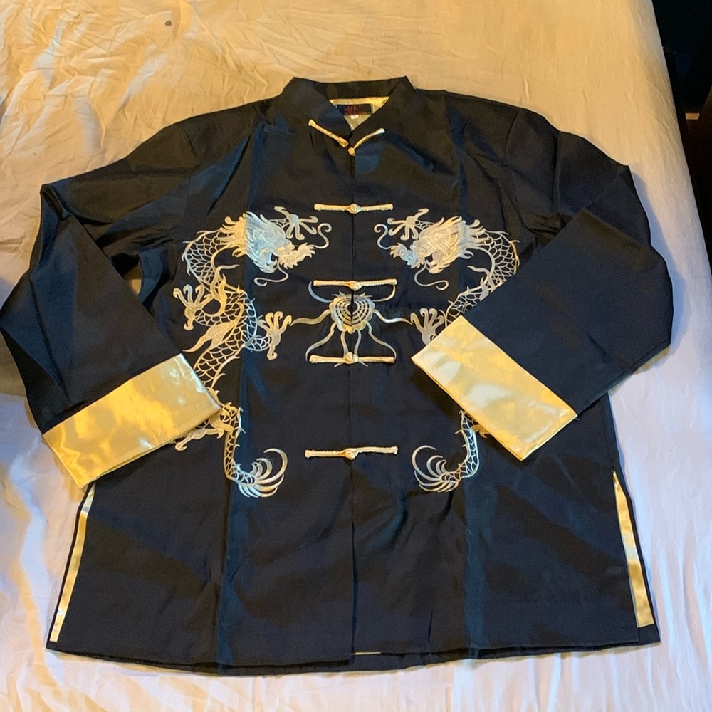 New in package black and gold kimono top. Has shoulder pads. Women’s large.